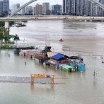 Flooded shops along a submerged riverside walk are seen by the overflowing Yongjiang River in Nanning, in China’s southern Guangxi region, on July 7, 2026. Photo by – / CN-STR / AFP